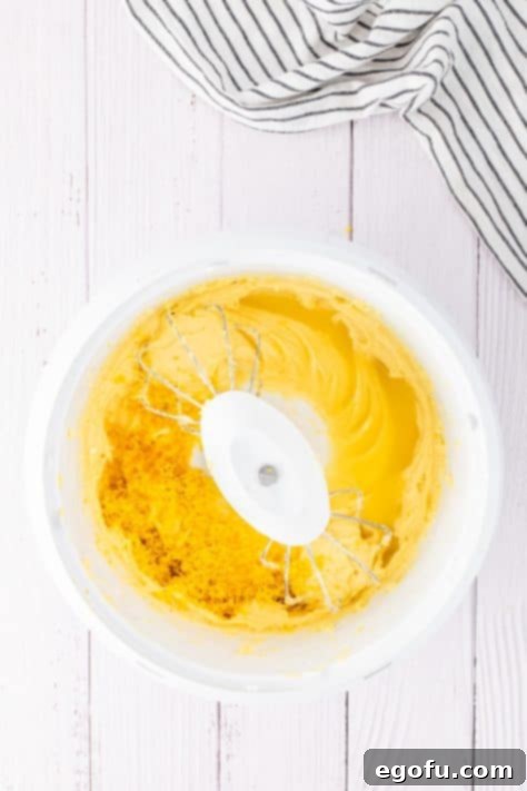 Lemon zest and extract being added to a cake batter.