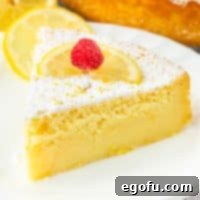 A slice of Lemon Magic Cake on a dessert plate, showcasing its beautiful layers.