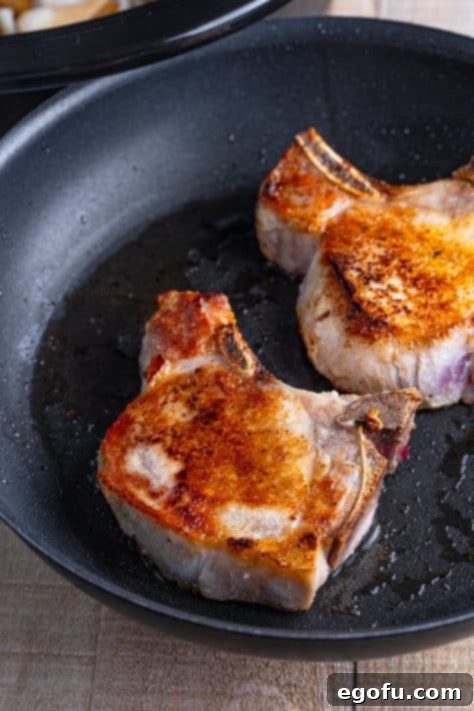 Easy One-Pot Pork Chops and Potatoes for Two 12 Seared pork chops in a pan.