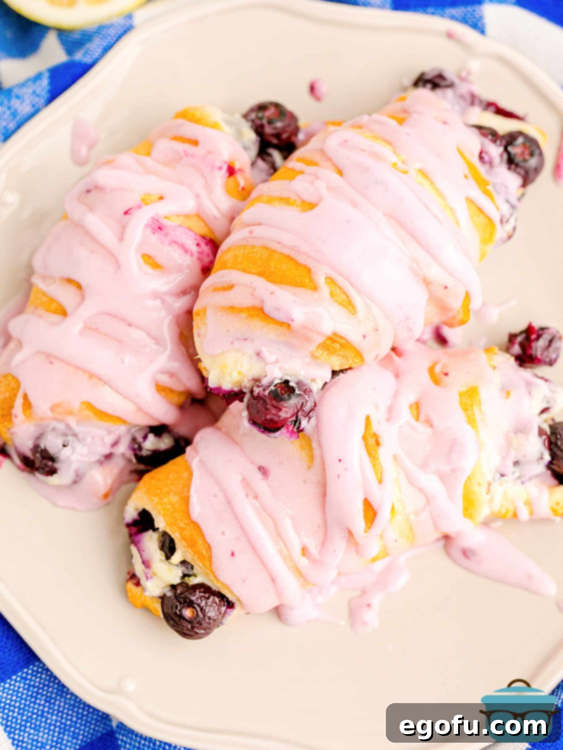 Looking down on a plate of Blueberry Cheesecake Crescent Rolls, showcasing their golden-brown exterior and creamy filling.