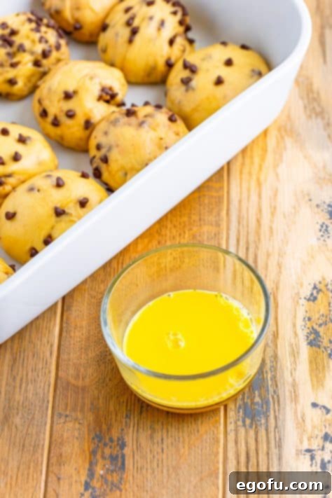 Indulgent Chocolate Hot Cross Buns 26 A small glass mixing bowl of egg yolks and water.