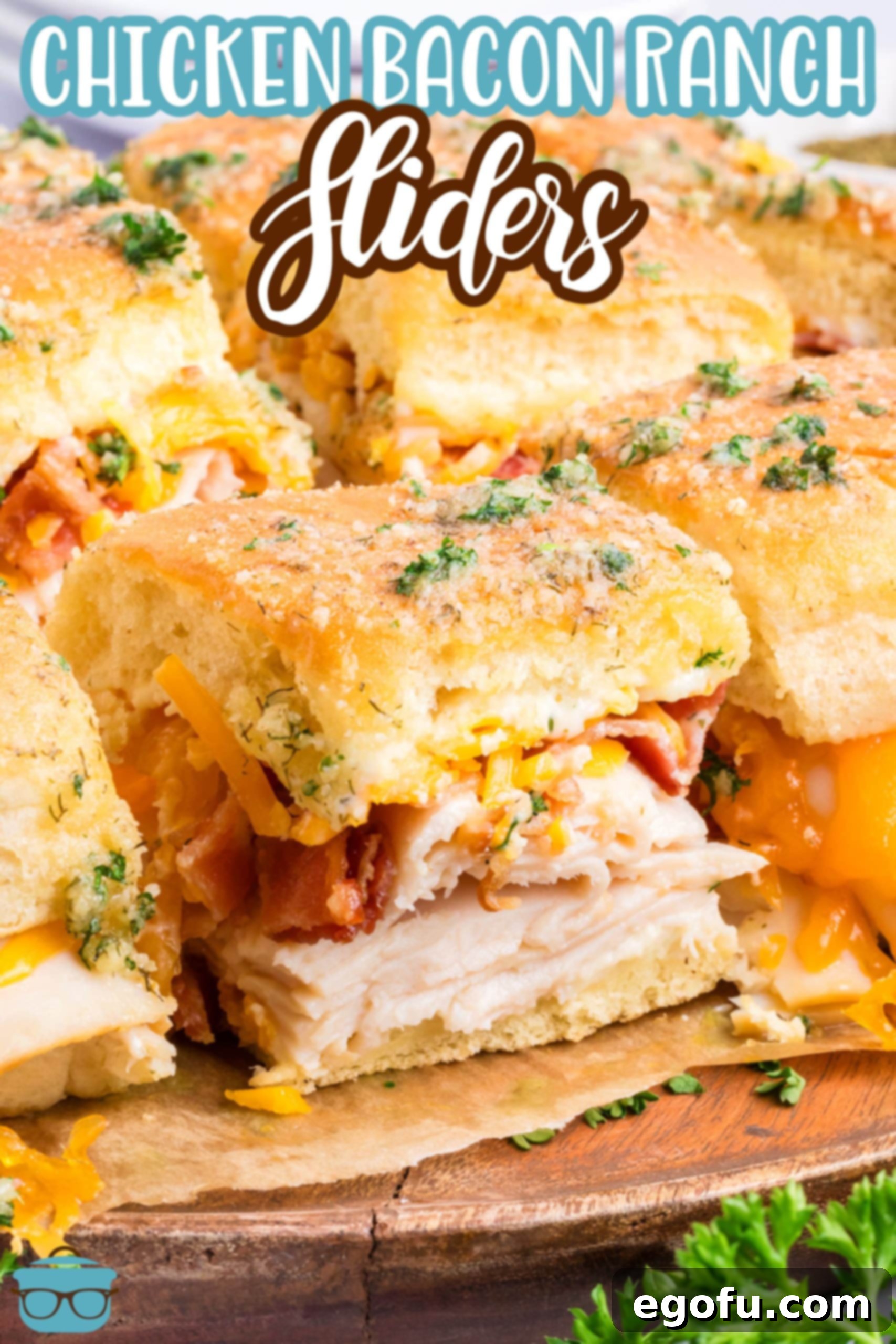 Close up view of several Chicken Bacon Ranch Sliders on a rustic wooden board.