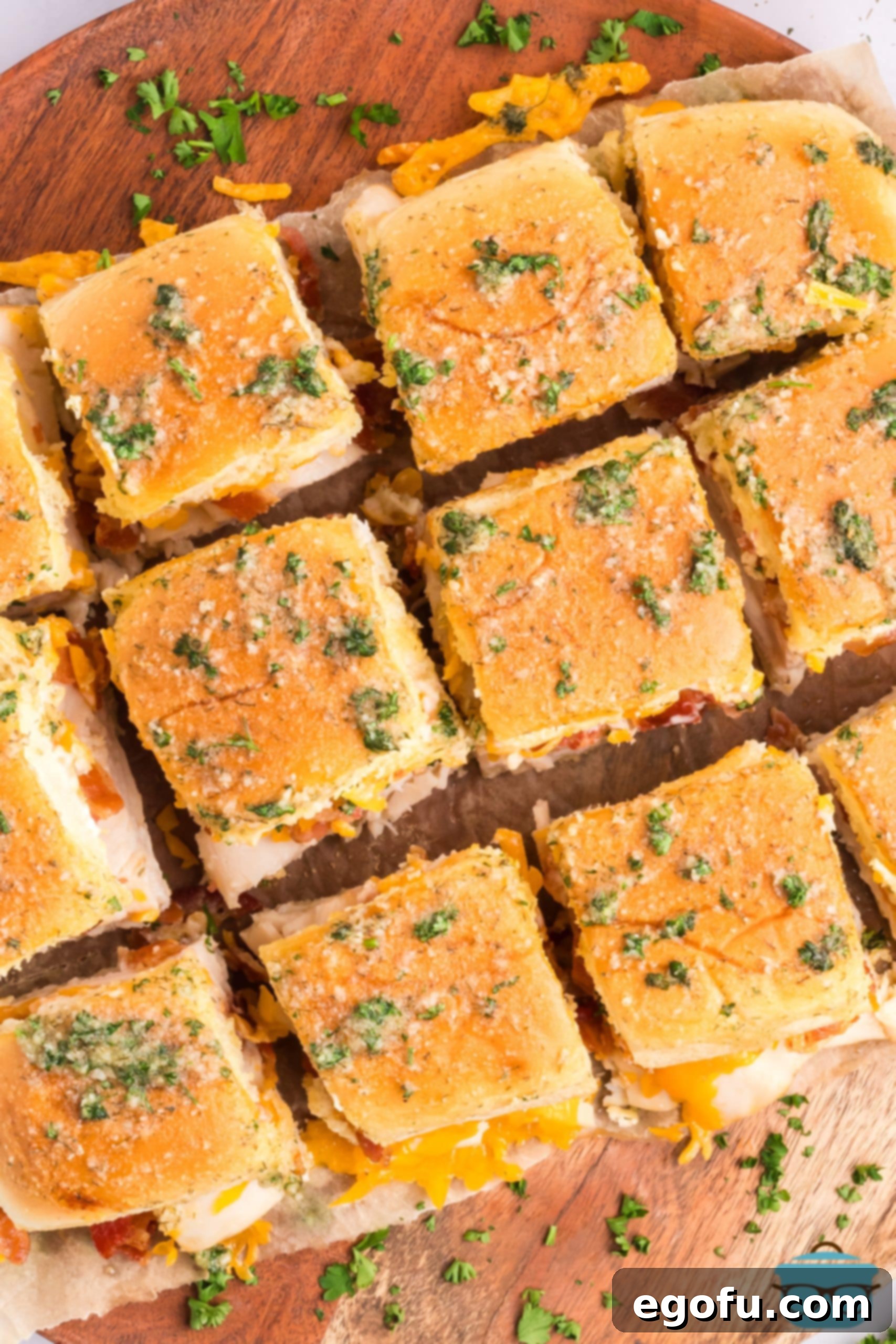 Looking down on a bunch of chicken bacon ranch sliders on a serving board.