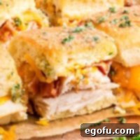 Up Close looking at some chicken bacon ranch sliders on a serving board.