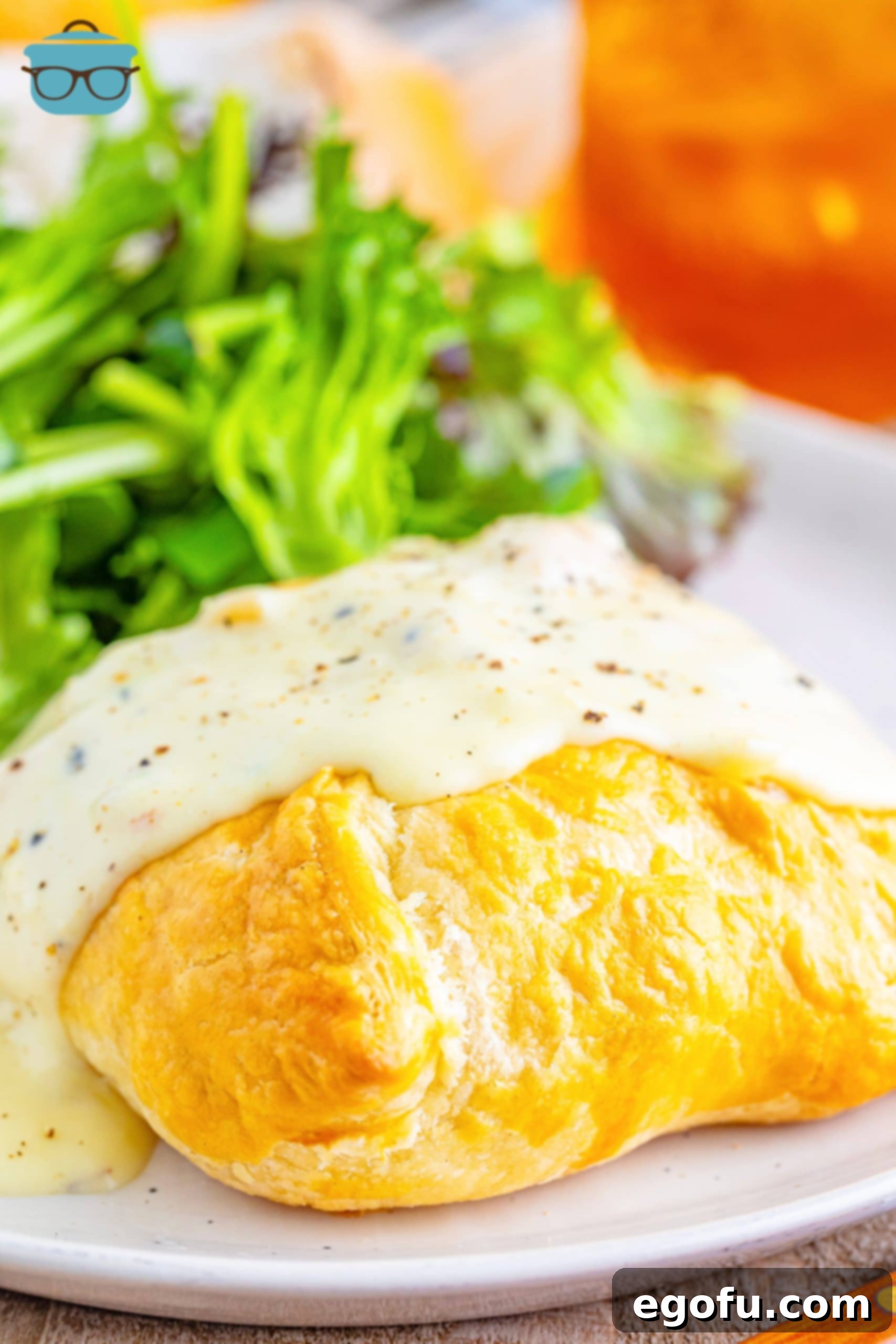 Chicken Wellingtons with sauce on a plate.