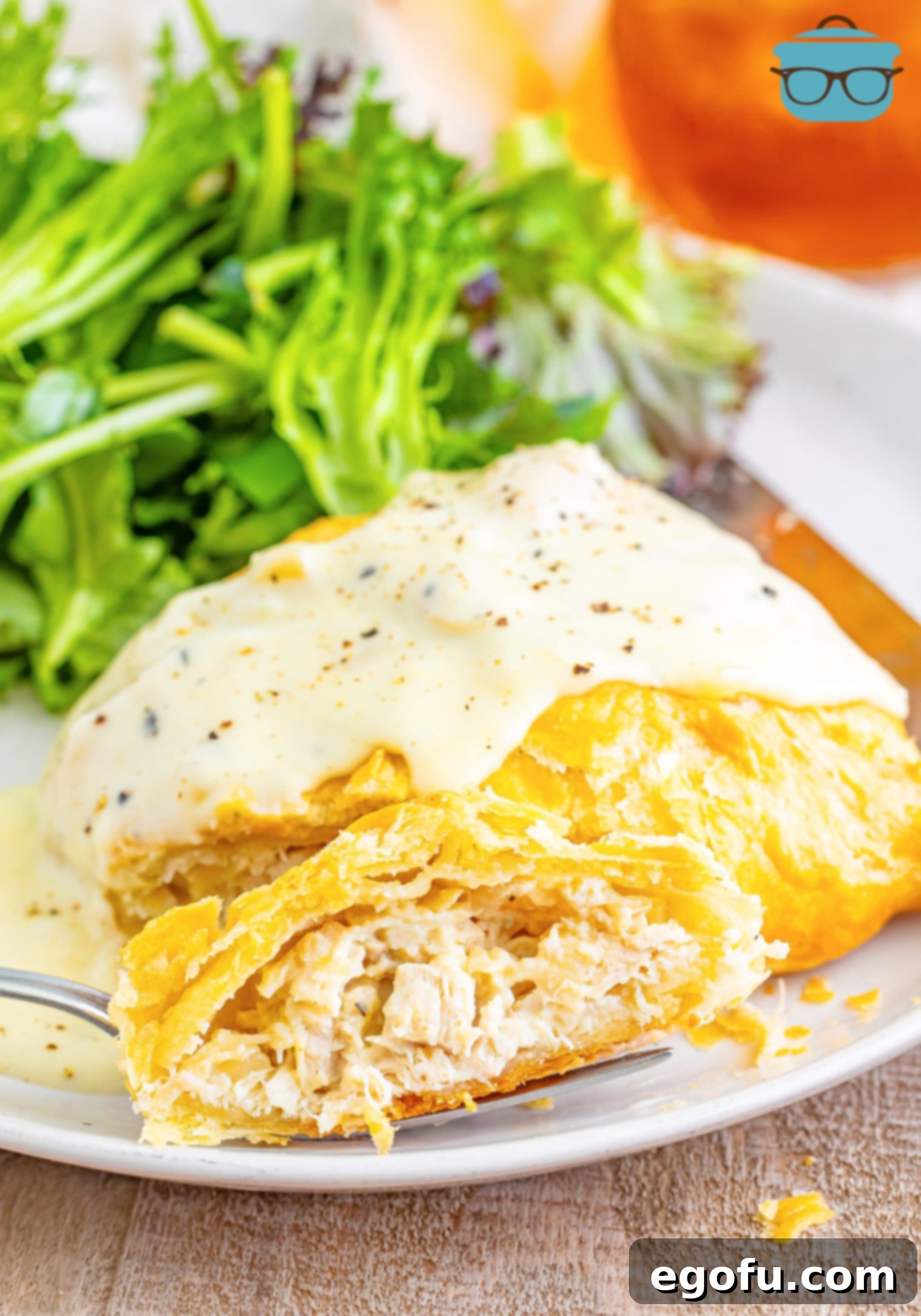 A plate with Chicken Wellingtons on it next to broccoli.