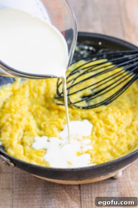 pouring heavy cream into skillet.