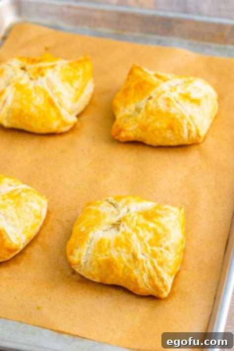 fully baked chicken wellingtons on a baking sheet.