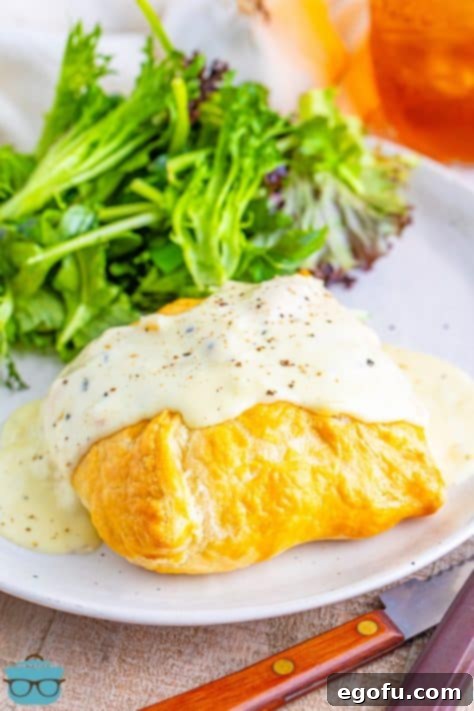 A plate with a serving of Chicken Wellington.