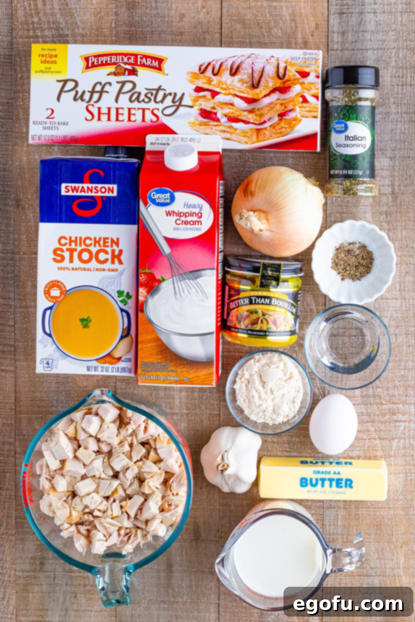 Butter, onion, garlic, flour, chicken stock, better than bouillion cube, heavy cream, milk, Italian seasoning, pepper, puff pastry, cooked chicken, egg, and water. 