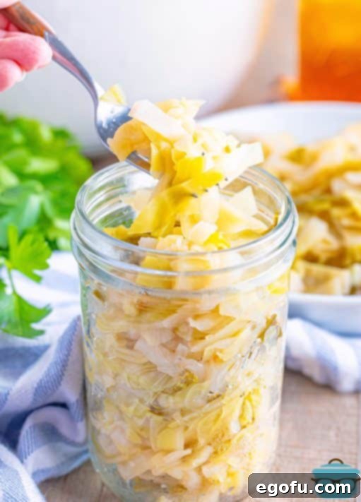 A jar of Quick Sauerkraut with a fork grabbing a bite.