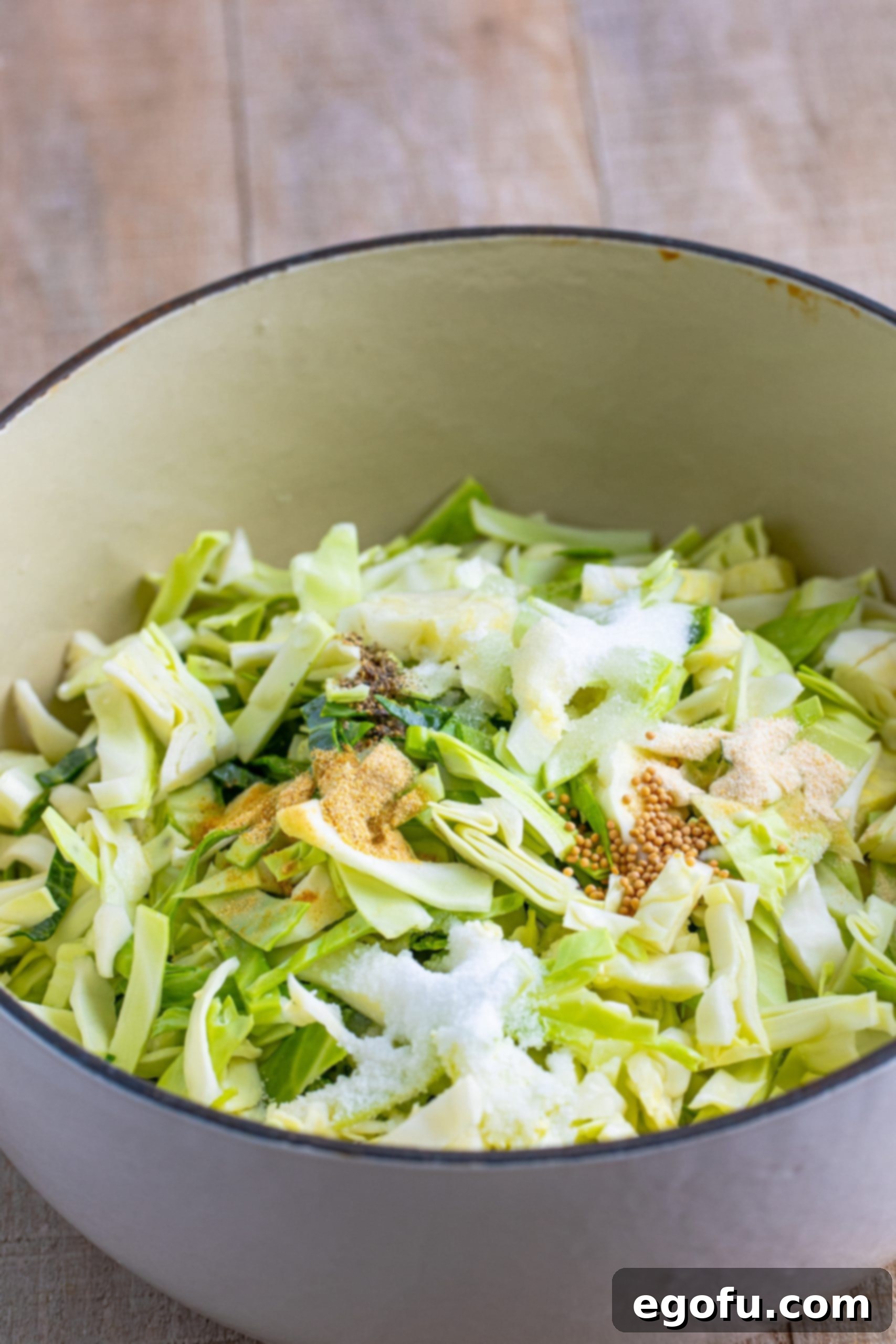 Cabbage, Add the water, apple cider vinegar, white vinegar, salt, sugar, pepper, garlic powder, mustard seeds, and onion powder in a pot. 