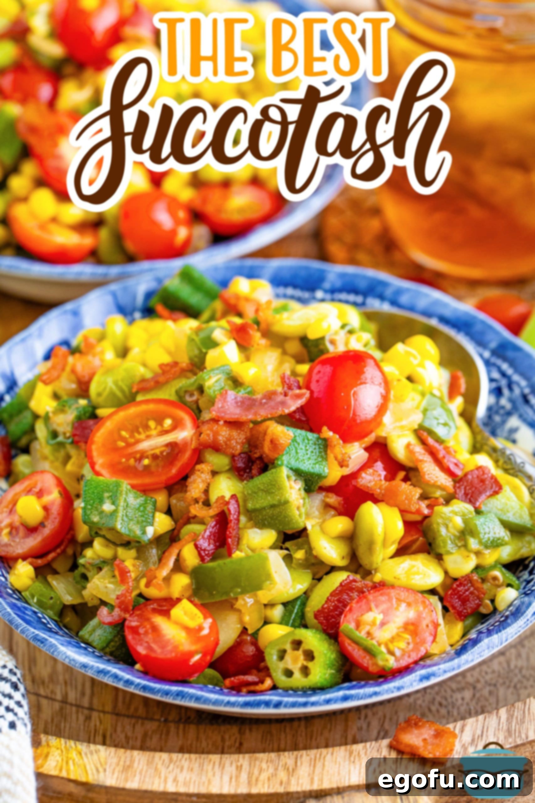 A blue bowl filled with a generous serving of colorful Succotash, showcasing the corn, lima beans, and tomatoes.