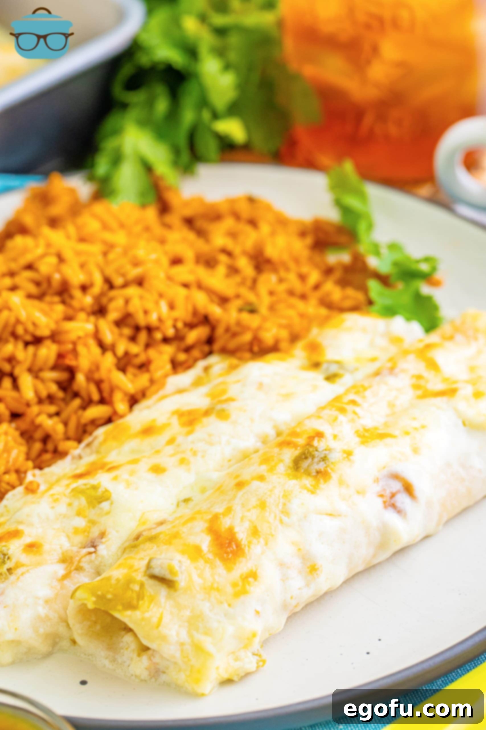 Date Night White Chicken Enchiladas 2 A plate with White Chicken Enchiladas and rice.