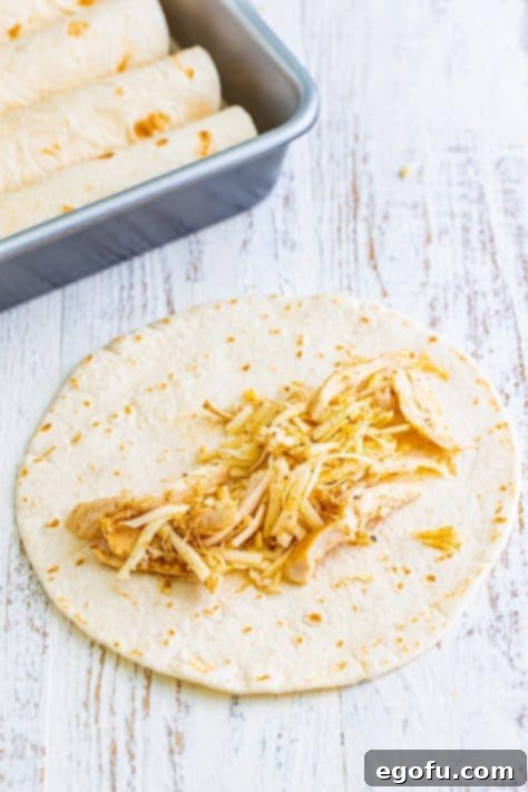 Date Night White Chicken Enchiladas 6 chicken filling shown inside a flour tortilla.