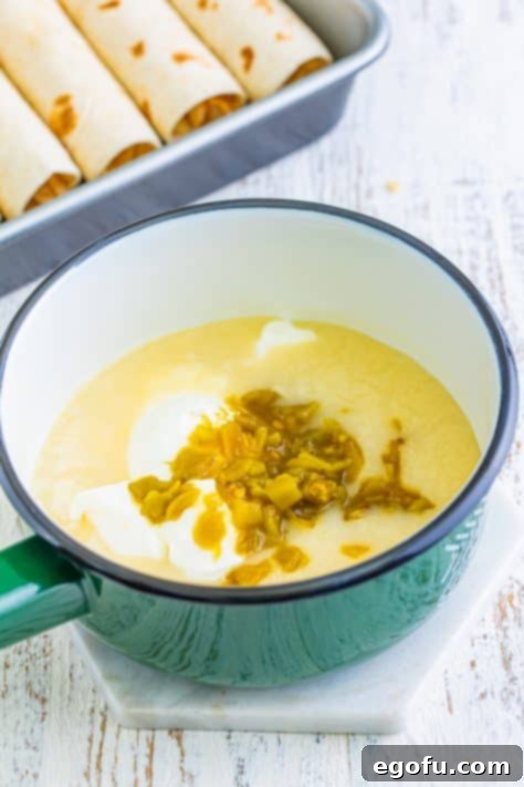 Date Night White Chicken Enchiladas 10 Sour cream and diced chiles added to the sauce, being whisked in.