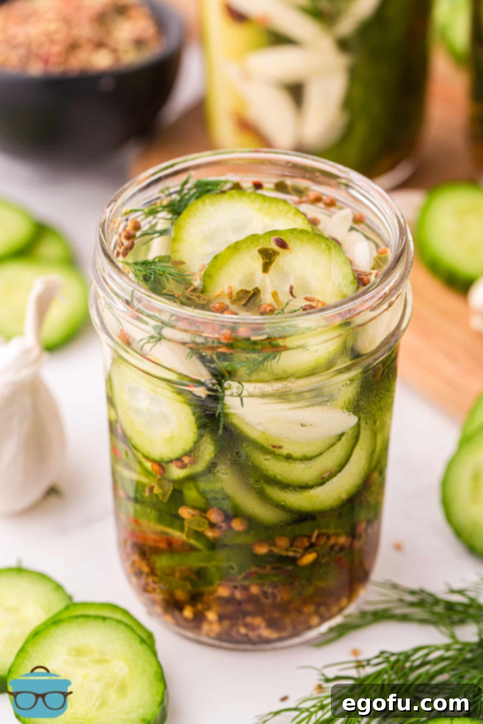 A jar of freshly made Refrigerator Pickles sitting on a kitchen counter, showcasing their vibrant green color and dill sprigs.