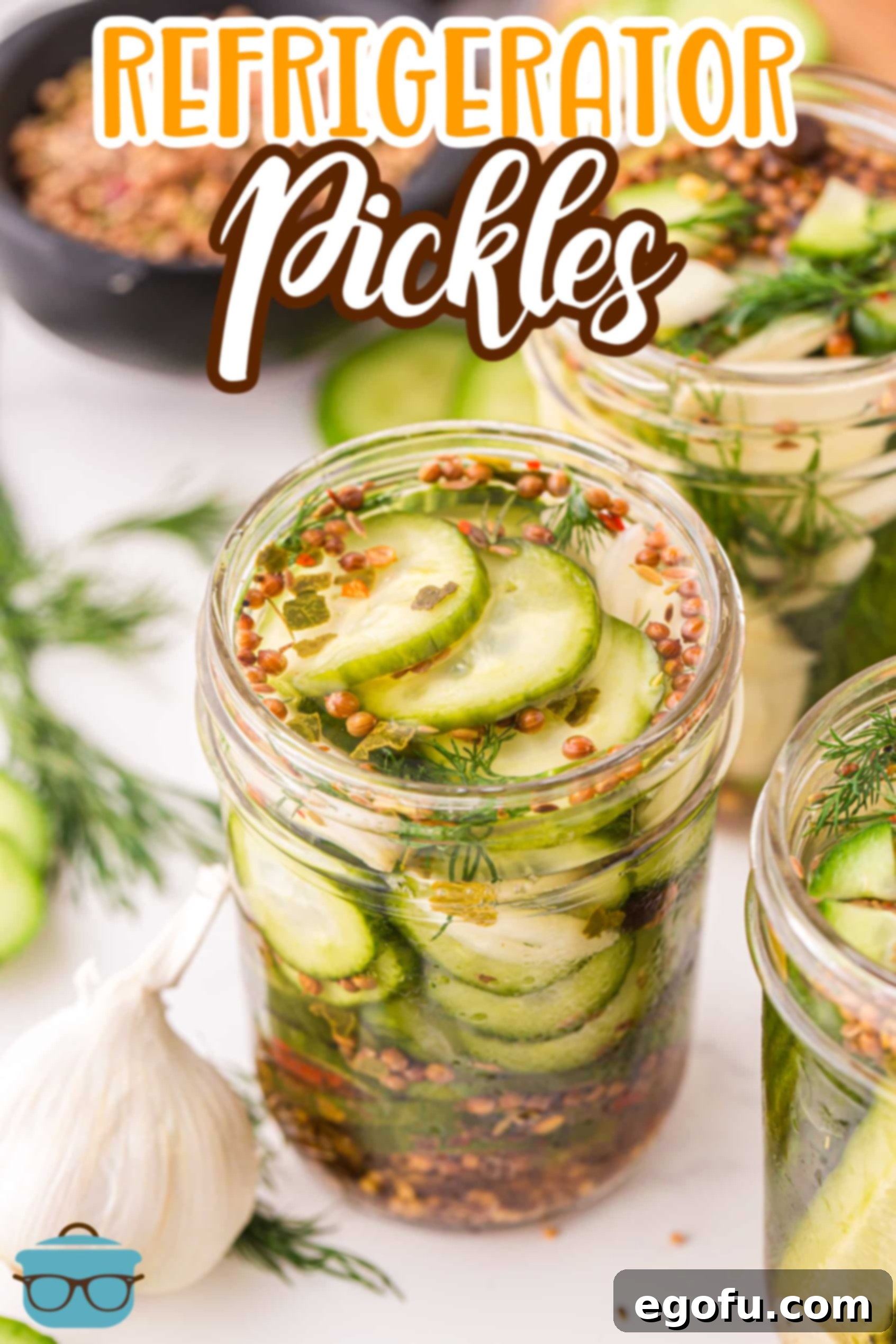 A beautifully arranged jar of homemade Refrigerator Pickles with fresh dill and garlic visible.