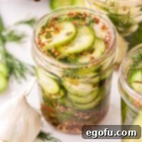 Looking down on an open jar of Refrigerator Pickles, revealing the crisp slices and fresh dill.
