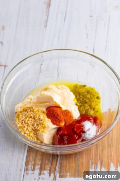 All the ingredients for homemade Thousand Island Dressing in a bowl to be mixed.