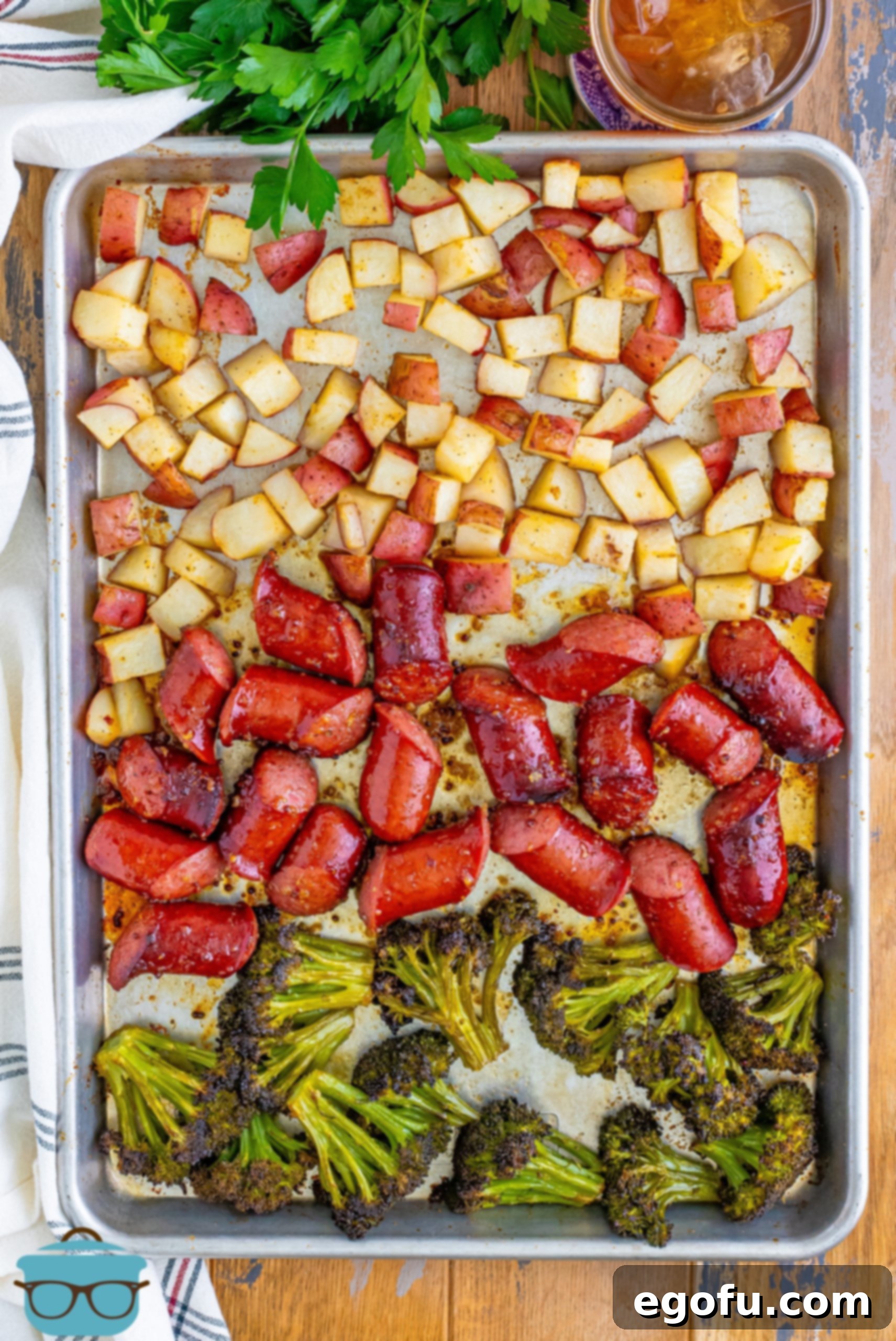 A Kielbasa Sheet Pan Dinner laid out on the sheet pan, glistening and cooked to perfection.