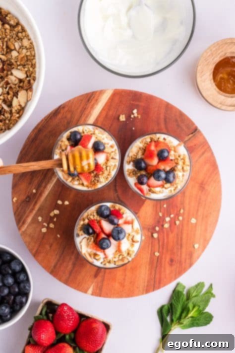 Honey being added to Yogurt Parfaits as a final touch.