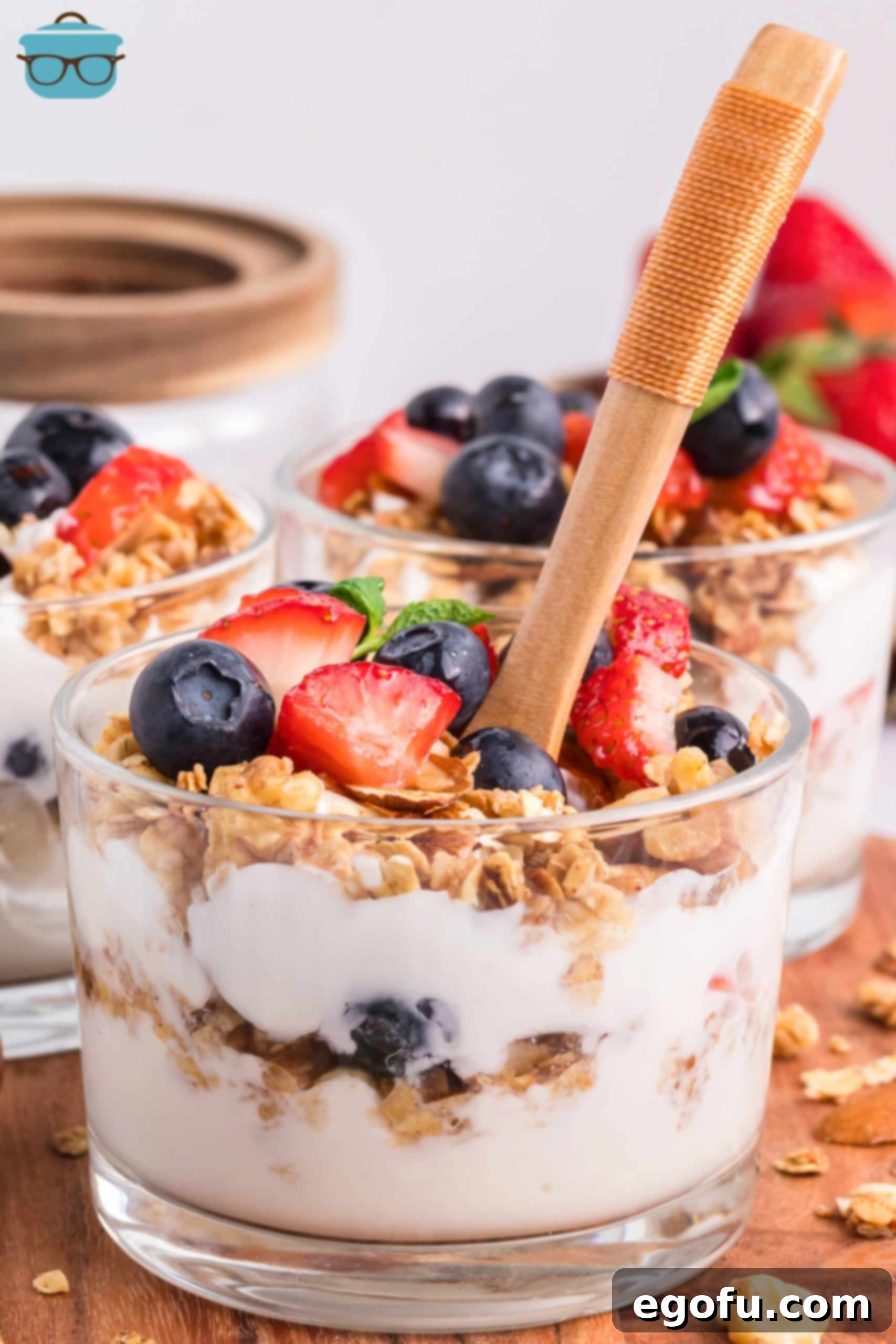 A spoon delicately placed into a finished Yogurt Parfait, ready to be enjoyed.
