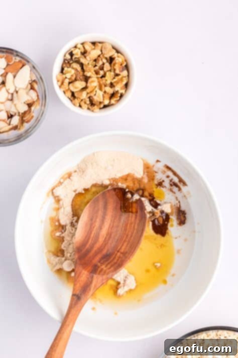 A bowl with syrup, coconut oil, vanilla, cinnamon, and salt mixed.