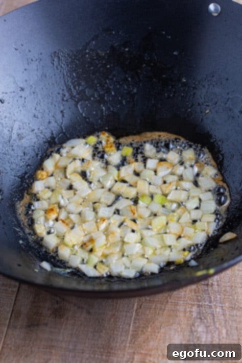 Butter and onions in a wok.