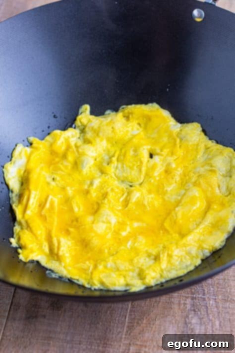 Scrambled eggs in a wok.
