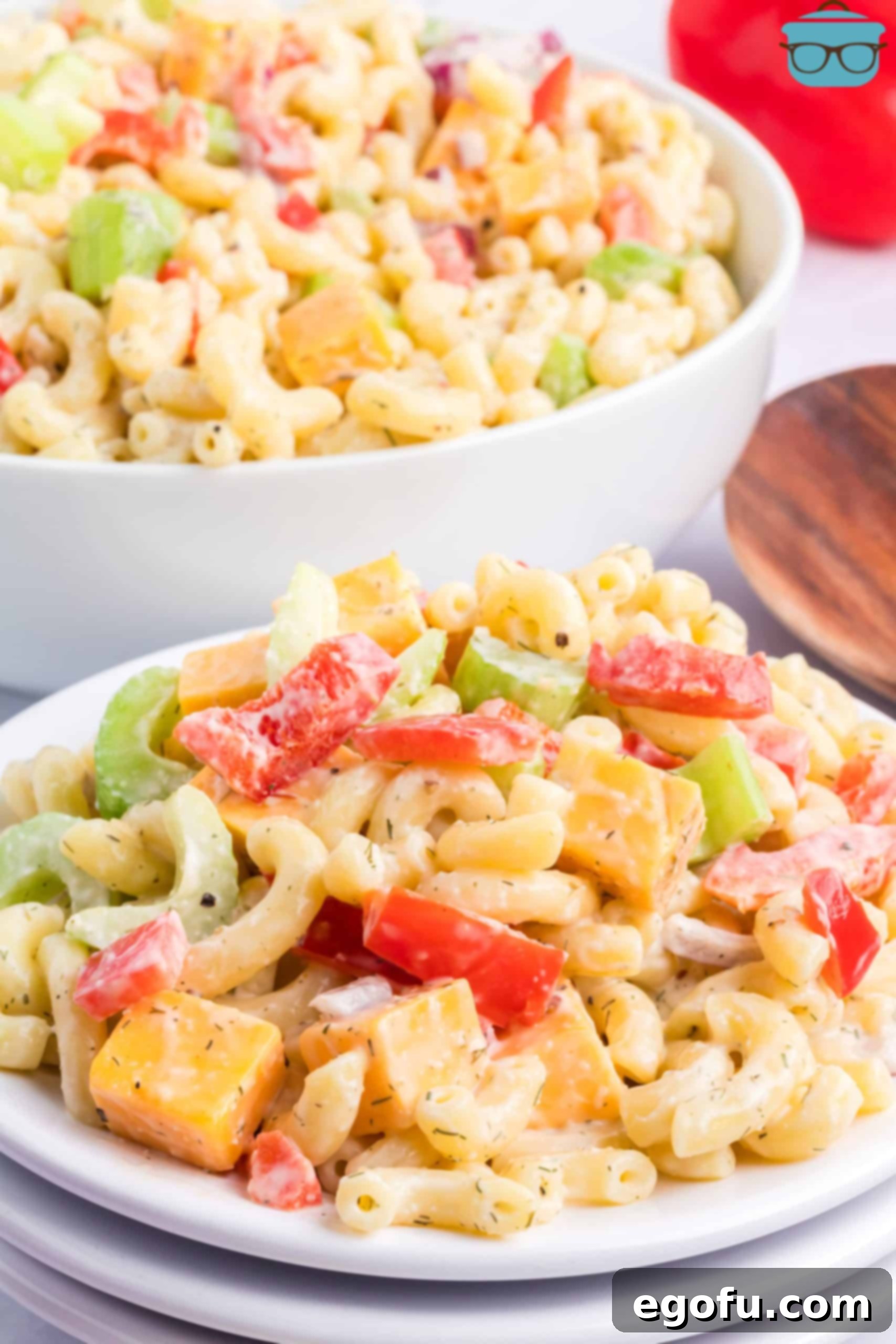 A large plate of vibrant Amish Macaroni Salad, featuring tender pasta, crisp vegetables, and creamy dressing, perfect for any summer gathering.