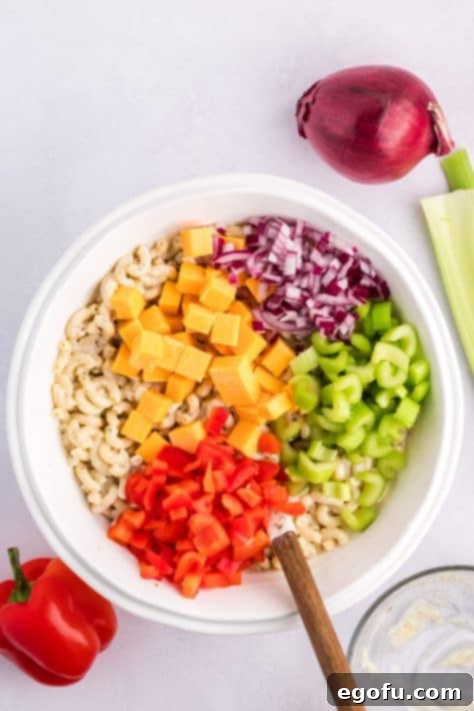Diced veggies on pasta in a bowl.