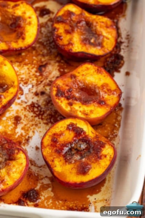 A baking dish containing baked peaches, perfectly cooked and tender.