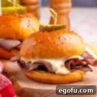 Ultimate Air Fryer Roast Beef Melts 7 Close up looking at an Air Fryer Roast Beef Sandwich with melted cheese.