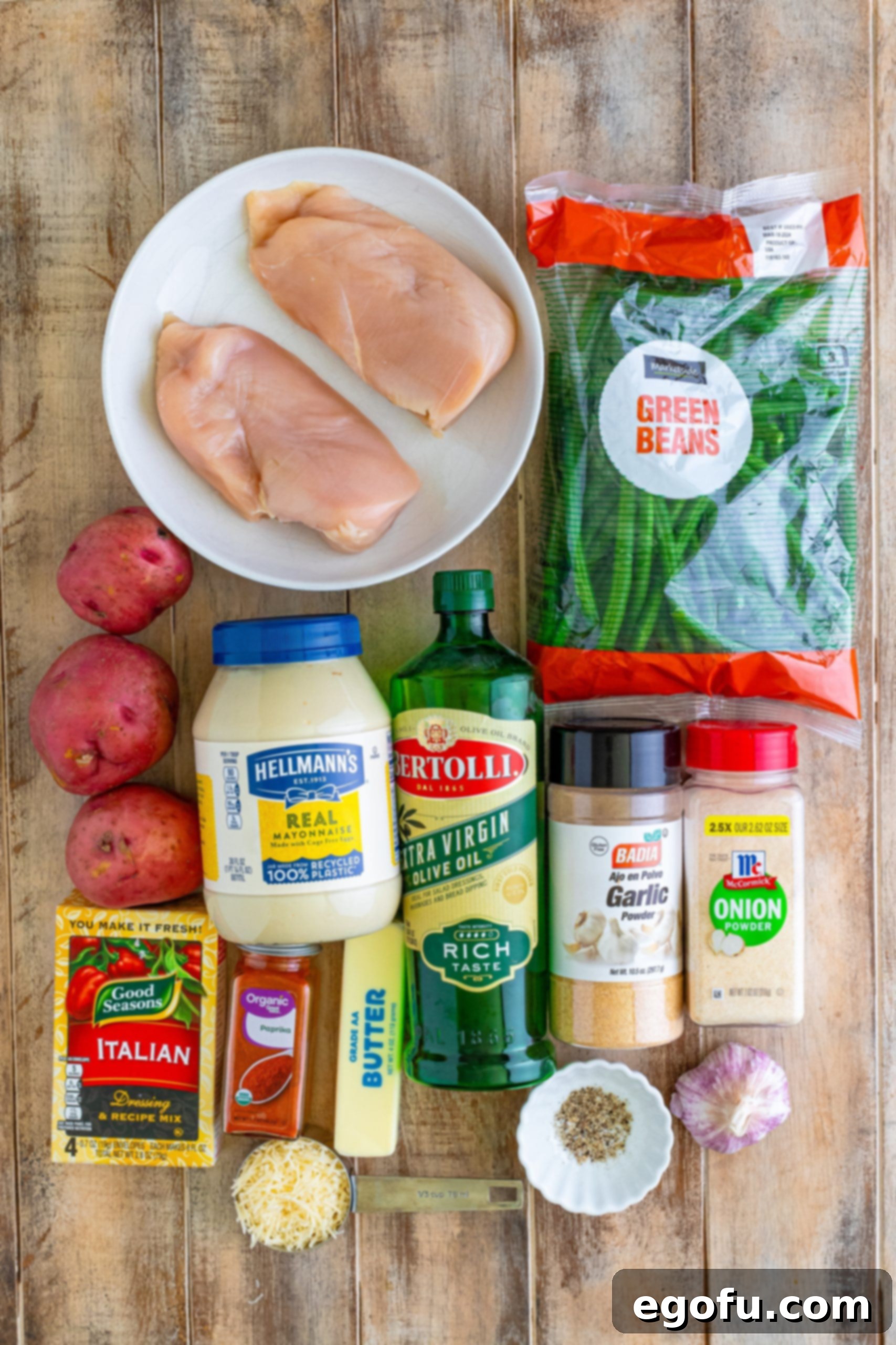 One-Pan Garlic Parmesan Chicken Dinner for Two 4 Chicken breasts, garlic powder, onion poder, fresh green beans, mayo, salt, pepper, red potatoes, butter, olive oil, Italian seasoning mix, parmesan cheese, and paprika.