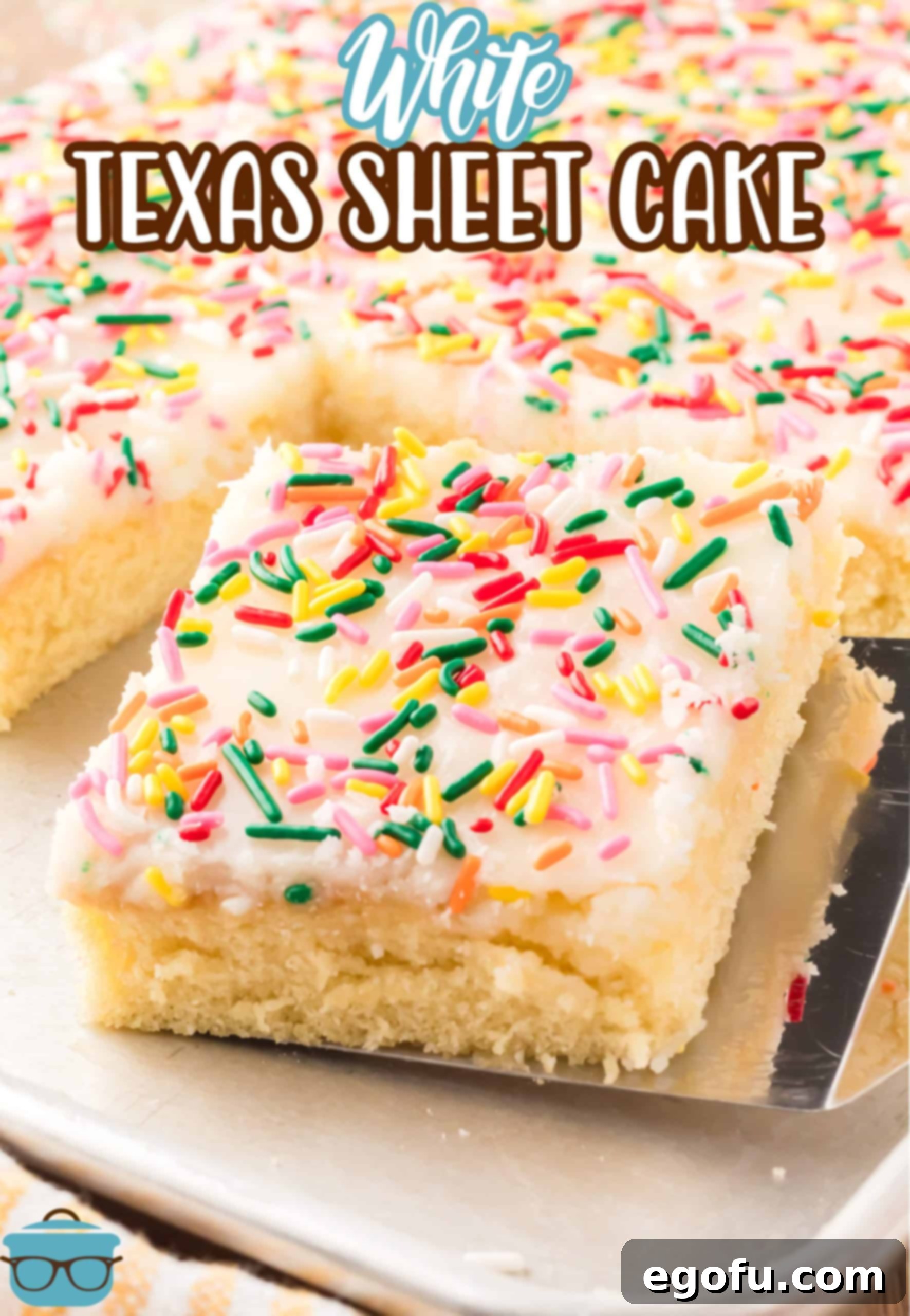 A beautiful slice of White Texas Sheet Cake topped with colorful sprinkles, served on a cake plate.
