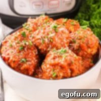 A perfectly portioned white bowl of Instant Pot Meatballs, garnished with fresh herbs, ready to be served.