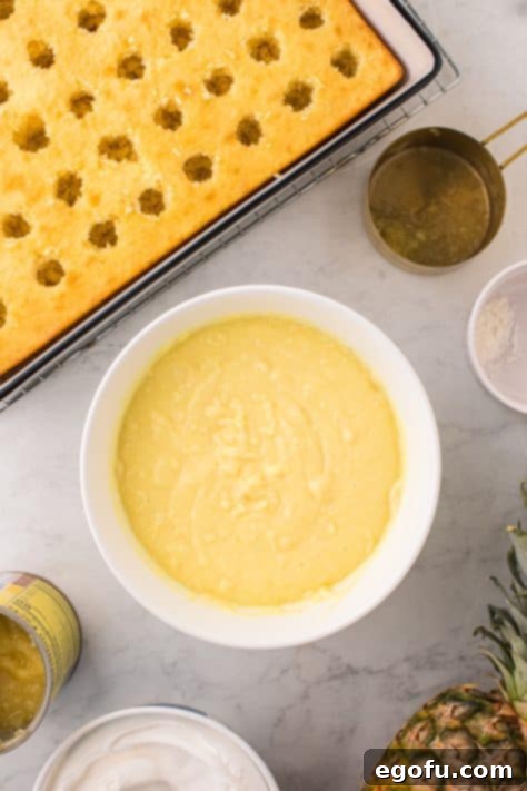 Sun-Kissed Hawaiian Poke Cake 14 A mixing bowl with instant pudding, milk and one cup of the crushed pineapple with juice.