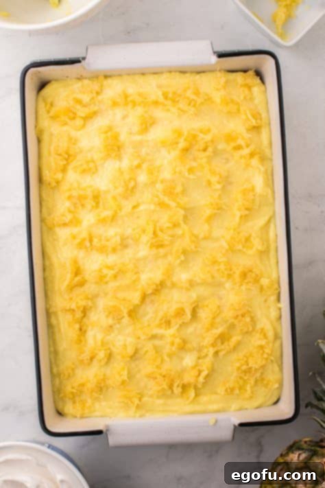 Sun-Kissed Hawaiian Poke Cake 16 Crushed pineapple on top of a pudding and cake.