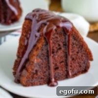 Velvet Chocolate Pudding Bundt 10 Up close looking at a slice of Chocolate Pudding Bundt Cake with a luscious chocolate icing.