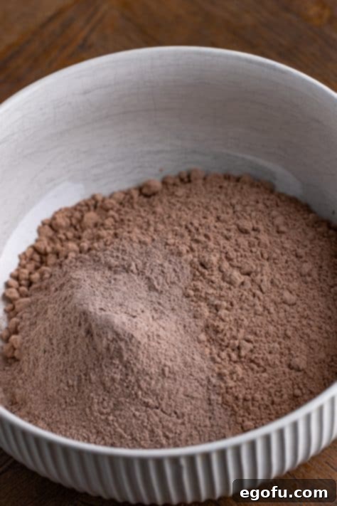 Velvet Chocolate Pudding Bundt 11 Chocolate cake mix and pudding mix in a bowl, followed by wet ingredients added.