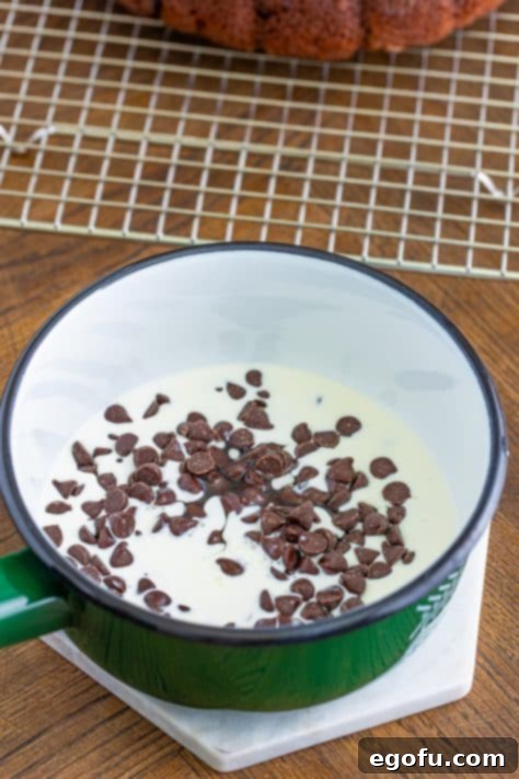 Velvet Chocolate Pudding Bundt 16 Chocolate chips, heavy cream, and corn syrup in a medium-sized sauce pot.