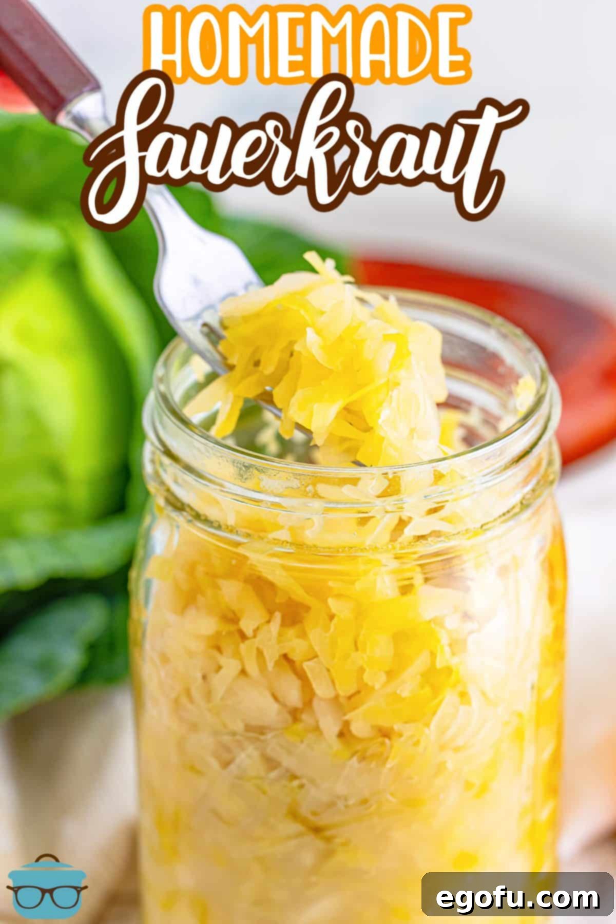 Fermented Goodness at Home 3 A fork holding some homemade sauerkraut over a jar.