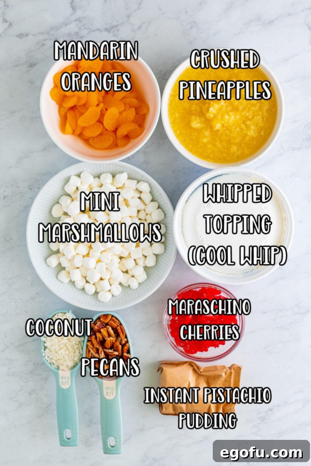 Pineapple, oranges, mini marshmallows, Cool Whip, Coconut flakes, maraschino cherries, pecans, and pistachio pudding mix.