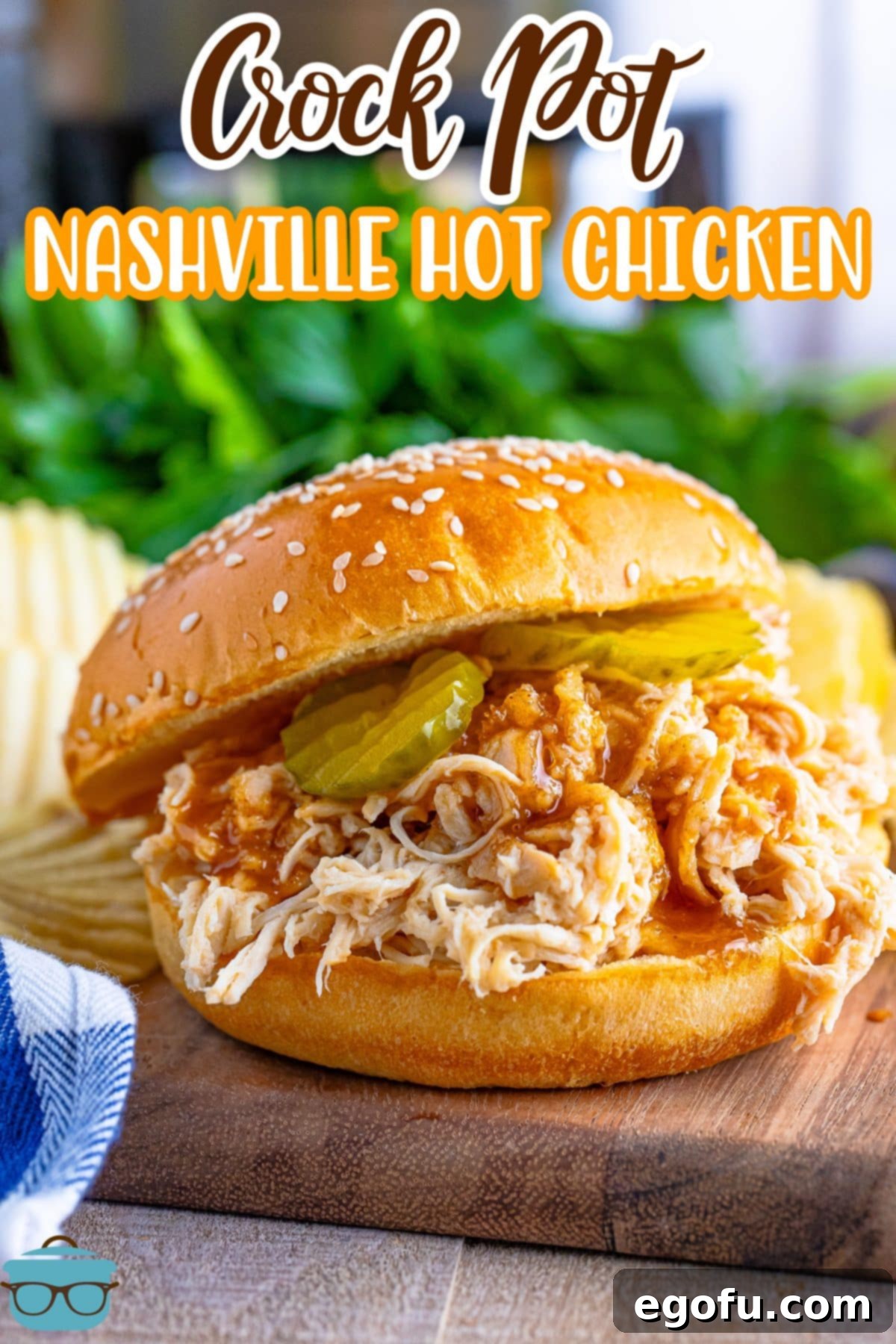 An overflowing Crock Pot Nashville Hot Chicken sandwich on a cutting board.