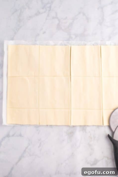 Puff pastry dough rolled out and ready to be cut into squares.