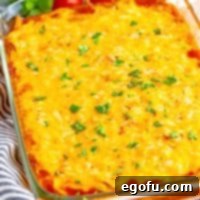 Cheesy Chicken Enchilada Fiesta 10 Close up looking down on a baking dish with Chicken Enchilada Casserole.