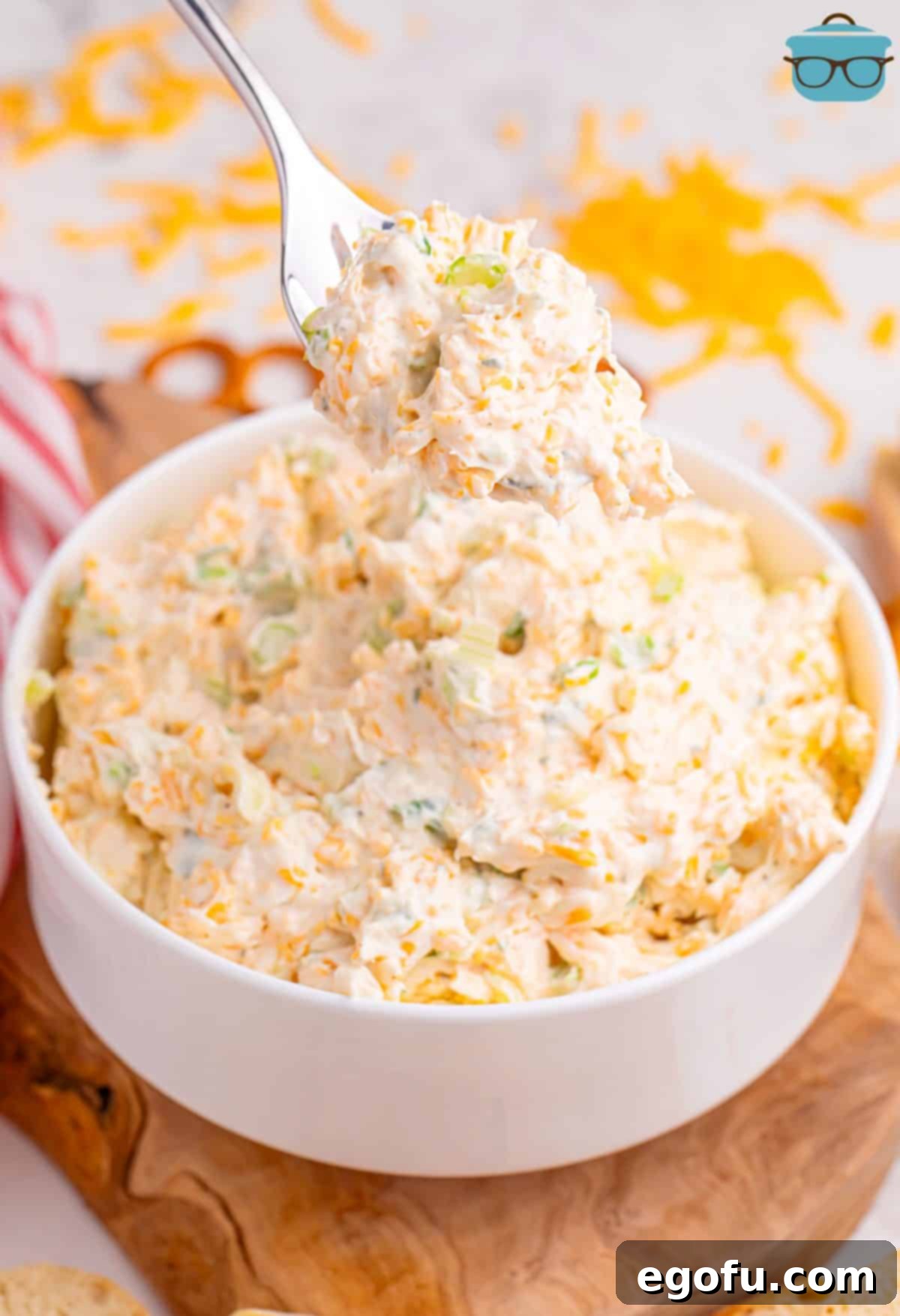 A fork holding a generous scoop of creamy Cheddar Ranch Dip, ready to be enjoyed.