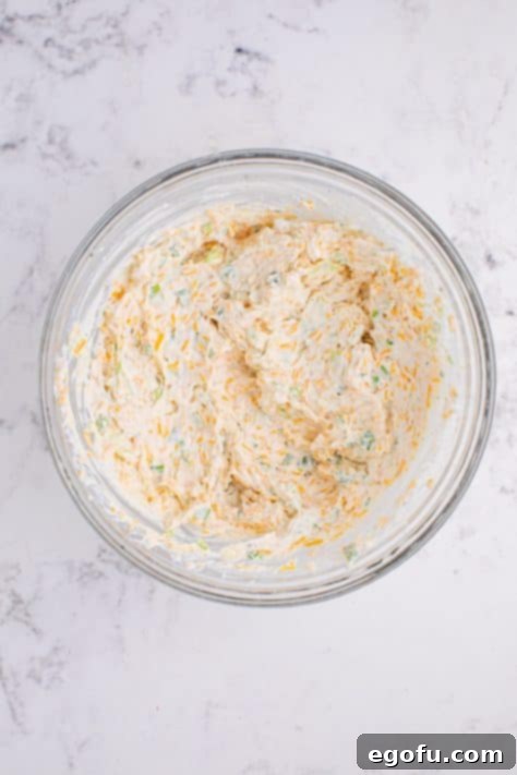 A mixing bowl with Cheddar Ranch Dip after ingredients have been combined into a creamy mixture.