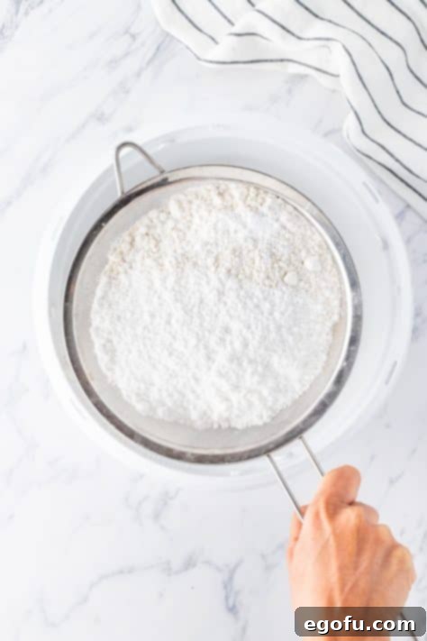 sifting flour into a bowl.